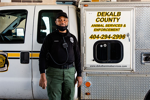 dekalb animal enforcement officer smiling in front of a truck